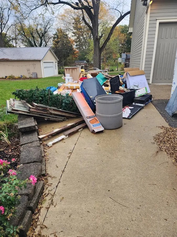 Dumpster being loaded with debris for 30 Yard Dumpster Rental in Bayside